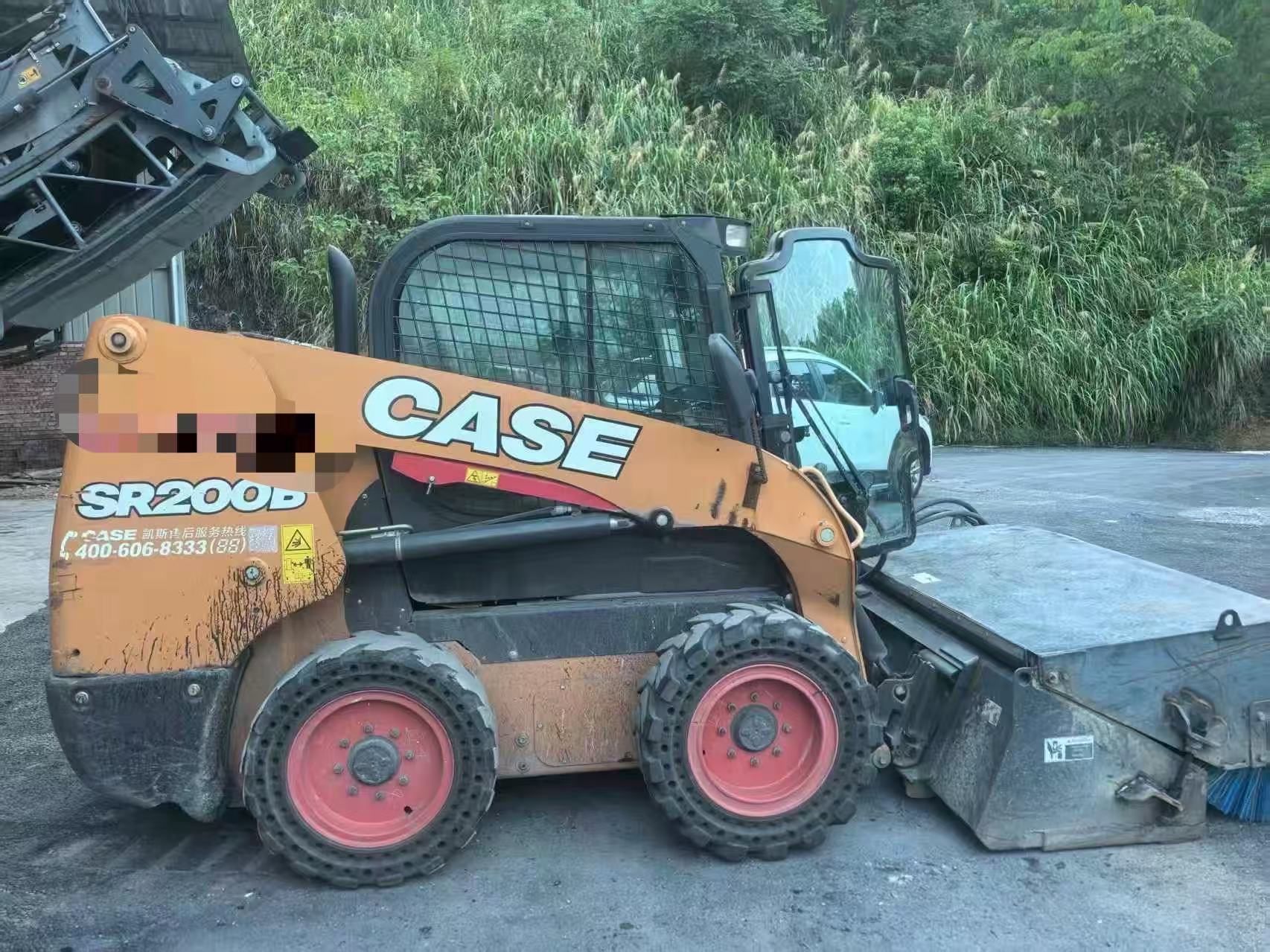 Second-hand Case SR200 skid steer loader and sweep